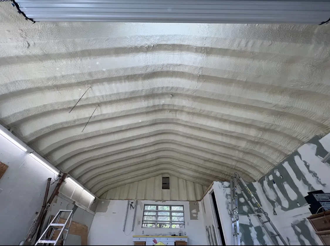 Spray polyurethane foam applied to the underside of a metal roof deck in Battlefield